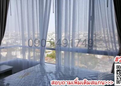 Spacious bedroom with panoramic city view through large windows
