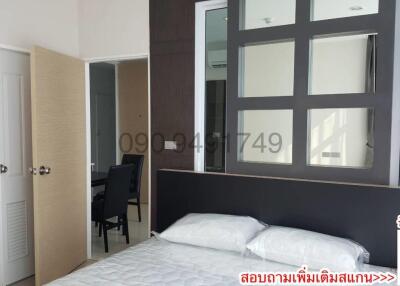 Modern bedroom with large window and reflection of balcony view