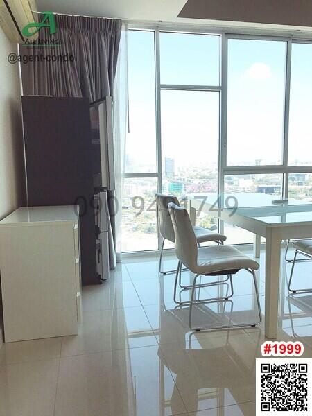 Modern kitchen and dining area with large windows and city view