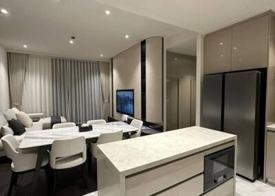 Modern kitchen with integrated dining area and sophisticated lighting