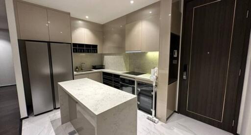 Modern kitchen with marble countertop and integrated appliances