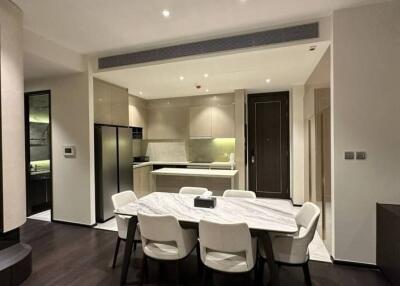 Modern kitchen with dining area featuring elegant furniture and integrated appliances