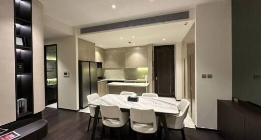 Modern kitchen with dining area featuring elegant furniture and integrated appliances