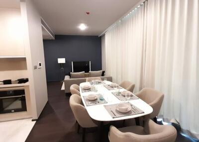 Modern dining room with adjacent living area in a contemporary apartment