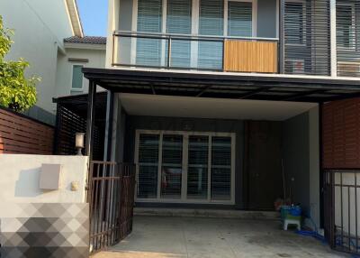 Modern two-storey house with balcony and carport