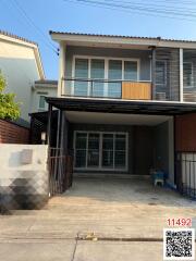 Modern two-storey house with balcony and carport