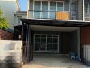 Modern two-storey house with balcony and carport