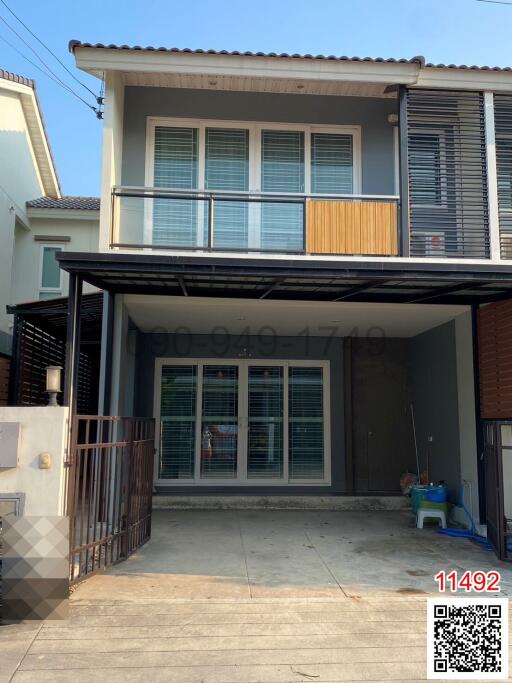 Modern two-storey house with carport and balconies