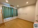 Spacious bedroom with wooden flooring and air conditioning