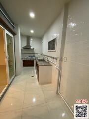 Modern kitchen interior with white tiles and stainless steel appliances