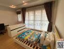 Well-lit bedroom with large window and children's bedding