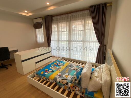 Well-lit bedroom with large window and children