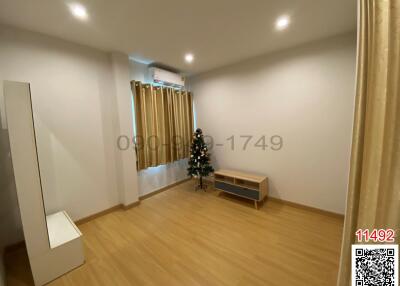 Spacious and modernly designed living room with wooden flooring and minimalistic decor