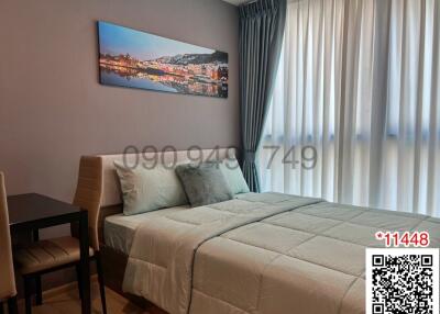 Cozy and stylish bedroom with a neatly made bed and cityscape artwork