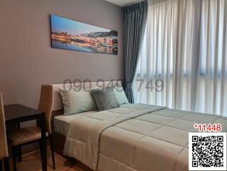 Cozy and stylish bedroom with a neatly made bed and cityscape artwork