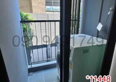 Small balcony of an apartment with washing machine and view of the exterior building