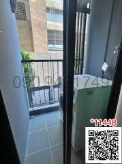 Small balcony of an apartment with washing machine and view of the exterior building