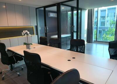 Modern office space with large conference table and natural lighting