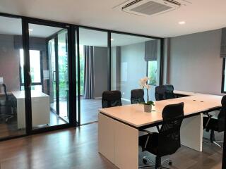 Spacious modern office with large meeting table and ample natural light