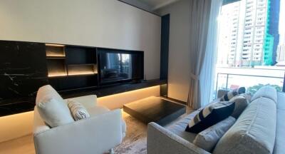 Modern living room with black marble media wall and plush seating