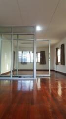 Spacious living room with large mirrors and wooden flooring