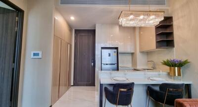 Modern kitchen with elegant design featuring built-in appliances and marble countertop