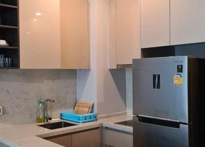 Modern kitchen with stainless steel appliances and marble countertops