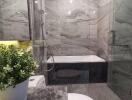 Modern bathroom with marble tiles, bathtub and shower