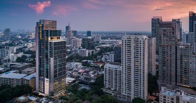 Panoramic view of a bustling city skyline at dusk