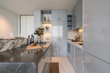 Modern upscale kitchen with large marble counter and sleek design