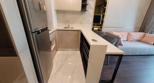 Modern kitchen with integrated living area featuring neutral tones