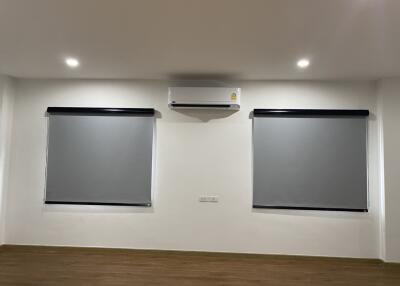 Modern living room with air conditioning and recessed lighting