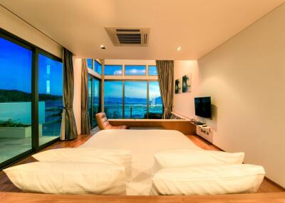 Luxurious beachfront bedroom with panoramic ocean views