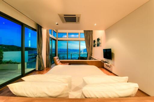 Luxurious beachfront bedroom with panoramic ocean views