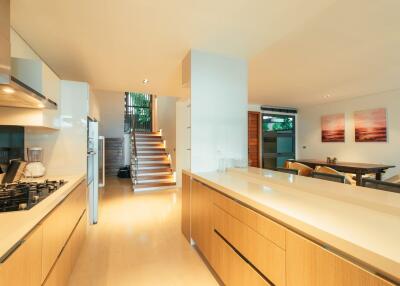 Modern kitchen with open-plan living space and staircase