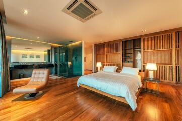 Spacious modern bedroom with wooden design features and ensuite bathroom