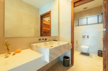 Modern spacious bathroom with large marble sink and sleek design