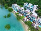 Aerial view of a luxury waterfront residential complex surrounded by lush greenery