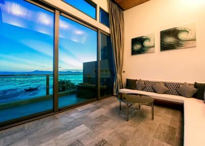 Modern living room with large glass windows overlooking the sea