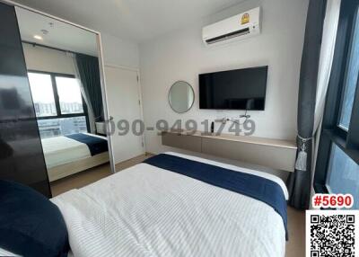 Modern furnished bedroom with ample natural light