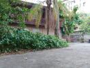 Exterior view of a two-story residential building with lush greenery