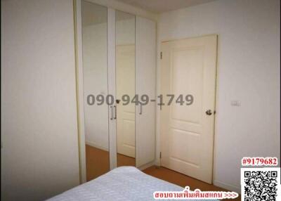 Cozy bedroom with built-in wardrobe and white door