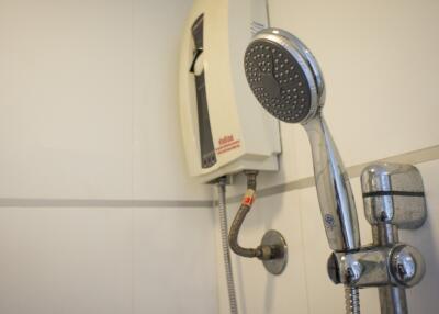 Modern bathroom fittings including shower head and wall-mounted telephone