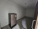 Spacious unfurnished living room with large refrigerator