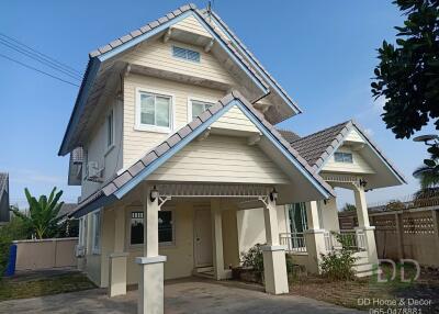 Exterior view of a two-story residential home with blue roofing