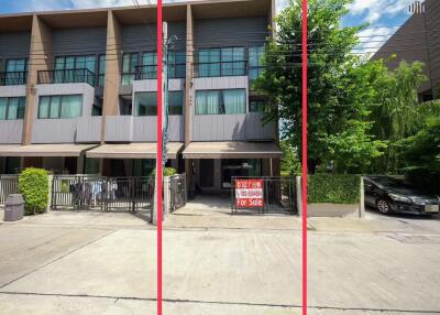 Three-story residential building with for sale sign