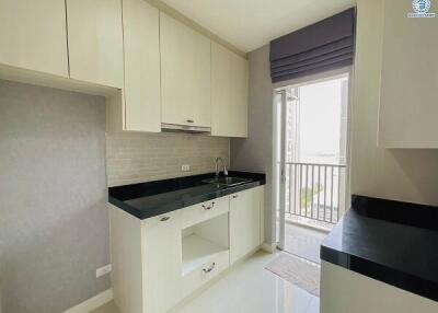 Modern kitchen interior with white cabinets and black countertop