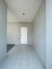 Bright and modern hallway with tiled flooring and white walls
