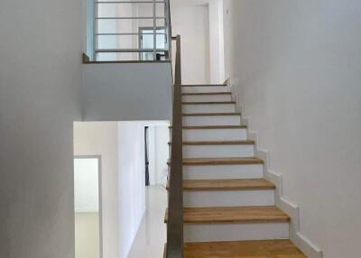 Modern staircase with wooden steps and white interior