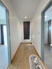 Bright and neatly designed hallway with wood flooring